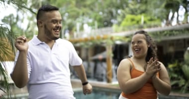 Young couple laughing and clapping.