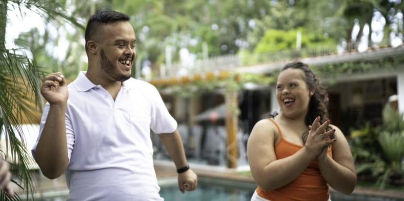 Young couple laughing and clapping.