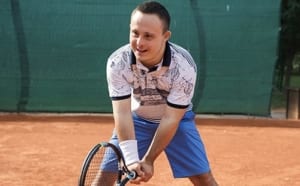 Adult male playing tennis.