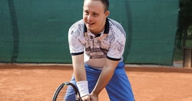 Adult male playing tennis.