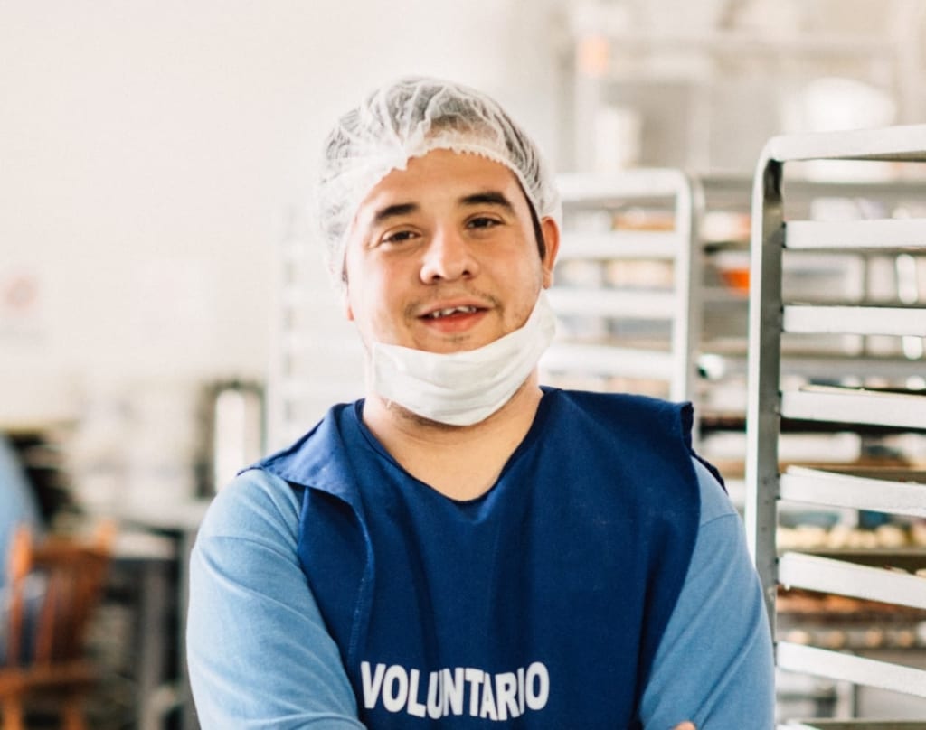 Young adult working at candy factory.