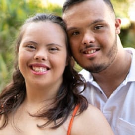 A young couple smiling.