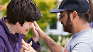 Man and young boy giving each other high-five.