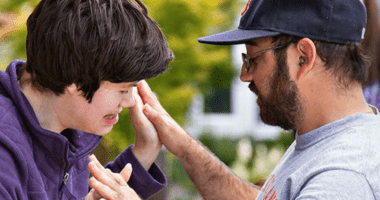 Man and young boy giving each other high-five.