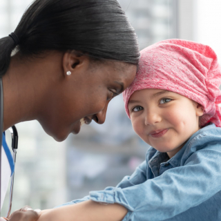 Nurse with little girl smiling.