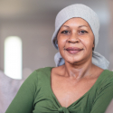 Woman looking directly at camera and smiling.